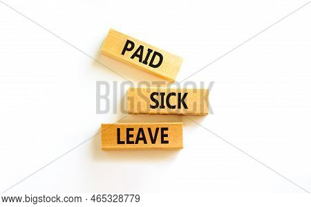 Paid Sick Leave Symbol. Concept Words Paid Sick Leave On Wooden Blocks. Beautiful White Table White 