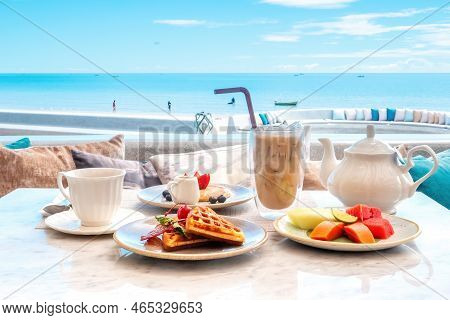 Sweet Breakfast In Cafe With Belgian Waffles, Pancakes With Fresh Berries, Tropical Fruits, Cup Of H
