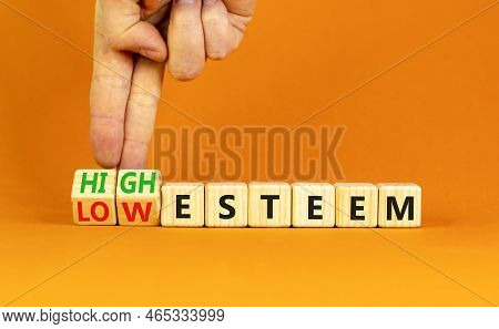High Or Low Esteem Symbol. Concept Words High Esteem And Low Esteem On Wooden Cubes. Businessman Han