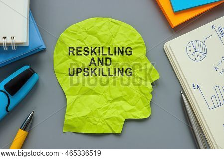 A Paper Head With Inscription Reskilling And Upskilling.