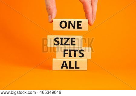 One Size Fits All Symbol. Concept Words One Size Fits All On Wooden Blocks. Businessman Hand. Beauti