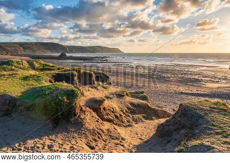 Beautiful Summer Sunset Landscape Image Of Widemouth Bay In Devon England With Golden Hour Light On 