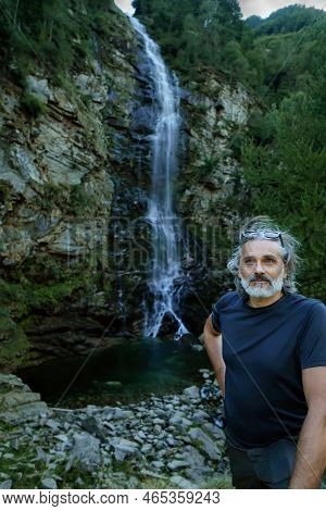 Man Under The Froda Waterfall In Switzerland