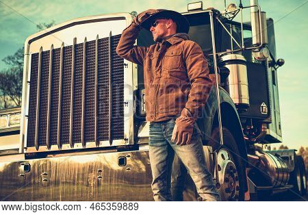 Caucasian Texas Cowboy Semi Truck Driver In His 40s. American Trucker And His Heavy Duty Vehicle. Gr