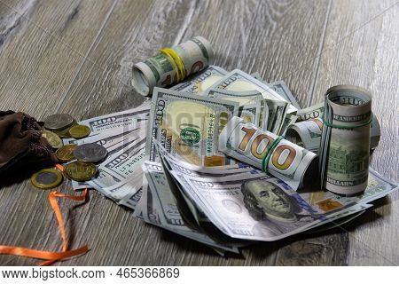 Closeup Of One Hundred Dollar Bills Of American Dollars And A Money Sack With Different Coins Of The