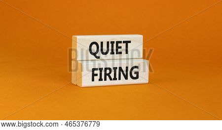 Quiet Firing Symbol. Concept Words Quiet Firing On Wooden Blocks. Beautiful Orange Table Orange Back