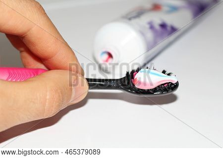 Mans Hand Holding A Toothbrush With Toothpaste