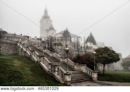 Ruzomberok, Slovakia - November 1, 2022:foggy Autumn Morning And Stairs To The Churh In Town Ruzombe