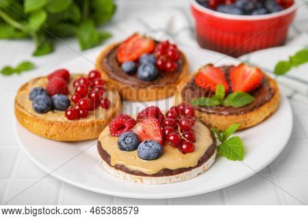 Fresh Rice Cake And Rusks With Different Toppings Served On White Table, Closeup