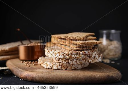 Rye Crispbreads, Rice Cakes And Rusks On Black Table