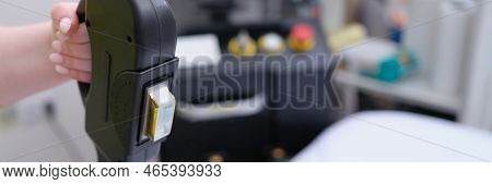 Apparatus For Hair Removal Closeup. Doctor Sets Epilation Parameters On Epilator Concept