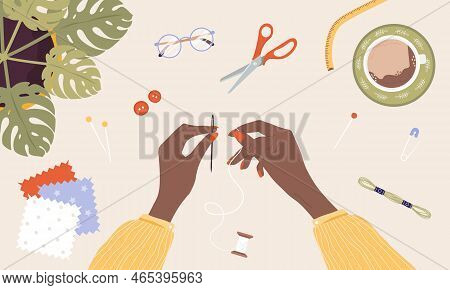 African Female Hands Insert Thread Into Needle. Woman Create Outfit. Top View. Needlework And Hobbie