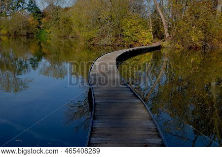 Floating Walkway Made Of Wooden Planks. Narrow Curved Paths On Stilts Driven Into The Bottom, Above 