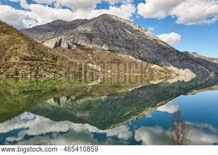 Picturesque Reservoir And Mountain Landscape In Riano. Mirror Effect. Spain