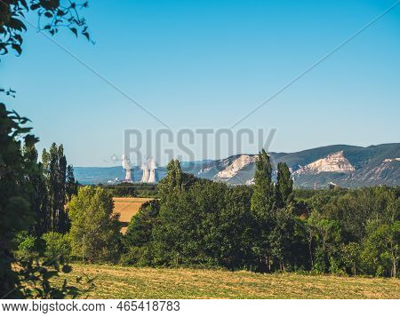 Panoramic View Of Fields And Mountains With Nuclear Smokestacks At Cruas, Southern France