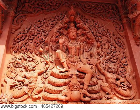 Temple Of Red Color In Thailand. The Facade Of The Temple Is Decorated With Figures Of Dragons And G
