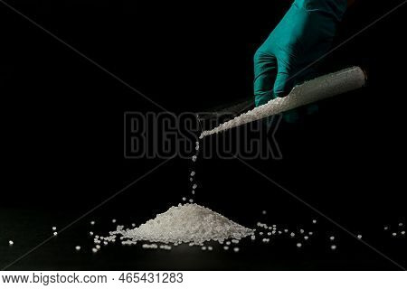 Close-up Of Plastic Polymer Granules. Hand Hold Polymer Pellets. Polymer Plastic. Compound Polymer.