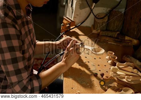 Female Using Power Working Tools Graver For Wooden Utensils Spoon