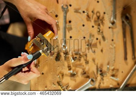 Woman Using Power Working Grinder Machine, Female Hand Grinds A Metal Nuts