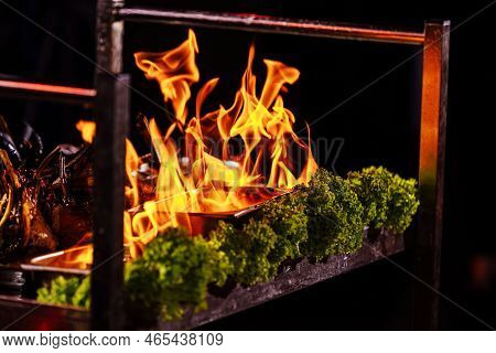Preparation Vegetables Or Meat Food In A Frying Pan With A Flame Of Fire. The Concept Of Restaurant 