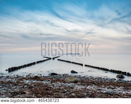 Crossed Breakwater. Dranske Beach, Ruegen Island. Morning Mood At Shore. Hiddensee Island With Shinn