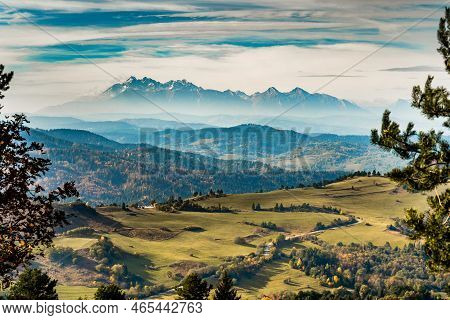Mountain Scenery With Green Pastures And Rocky Tatra Mountains In The Background During The Day.