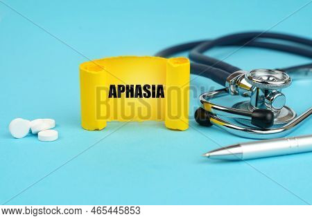 Medical Concept. On A Blue Surface, A Stethoscope, Pills, A Pen And A Yellow Sign With The Inscripti
