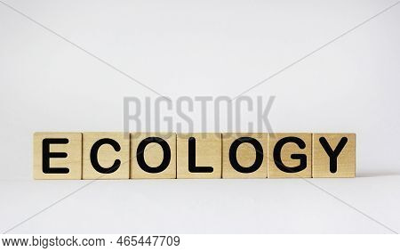 Ecology Symbol. Concept Word Ecology On Wooden Cubes. White Table, Copy Space. Business, Ecology And