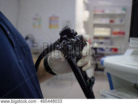 The Veterinarian Holds The Gastroscope Control Knob In His Hands. The Doctor Conducts A Gastroscopic