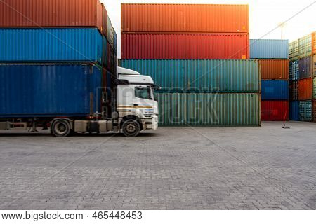 Truck While Loading In Logistic Shipping Yard With Cargo Container. Forklift Truck Handling Truck. L