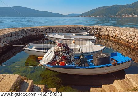 Montenegro, Adriatic Sea, View Of Bay Of Kotor Near Tivat City. Fishing Boats At Small Stone Jetty