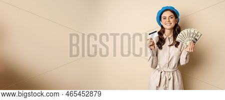 Microcredit And Money Concept. Young Stylish Woman Showing Credit Card And Dollars Cash, Smiling Hap