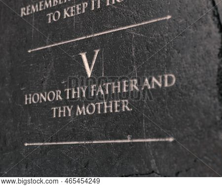 A View Of The Fifth Commandment Etched Into A Cracked Stone Tablet On An Isolated Background - 3d Re