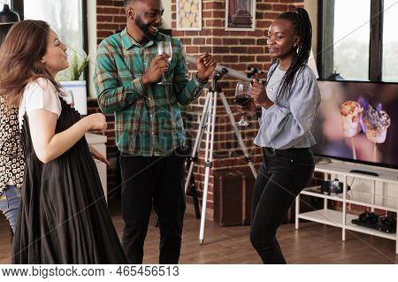 Cheerful African American Couple, Happily Dancing, Drinking Wine, Alcohol Accompanied By Caucasian Y