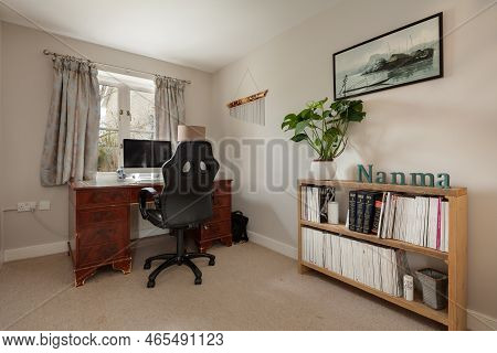 Fen Ditton, England - Jan 10 2019: Furnished House Study With Desk,chair And Bookcase