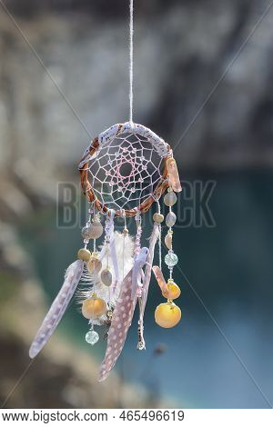 Handmade Native American Dream Catcher On Background Of Rocks And Lake