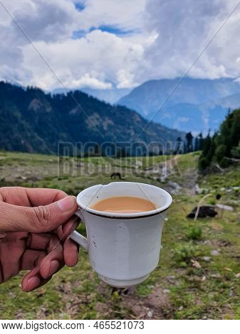 A Selective Focus On Tea Cup At Blur Top Mountain View Of Kalam Valley In Clouds