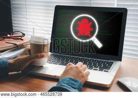 Software Development And Debugging Concept, Person Hand Using Laptop Computer With Bug Software Icon