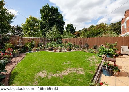 Newmarket, Suffolk, England - August 21 2018: Suburban Mews Landscaped House Garden With Patio And L