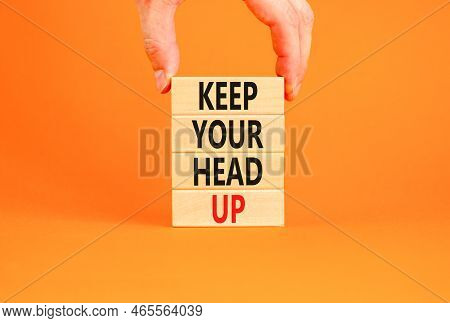 Keep Your Head Up Symbol. Concept Words Keep Your Head Up On Wooden Cubes. Beautiful Orange Table Or
