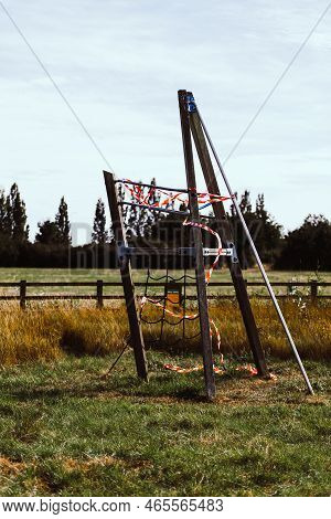 Hazard Tape Covering Wooden Playground In Field