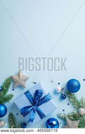 Christmas Concept. Top View Vertical Photo Of Blue White Baubles Stylish Giftbox With Ribbon Bow Glo