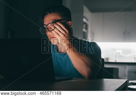 One Young Sick And Tired Man Feeling Bad Touching His Eyes And Face At Night After Over Work. Teenag