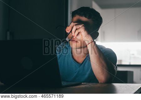 One Young Sick And Tired Man Feeling Bad Touching His Eyes And Face At Night After Over Work. Teenag