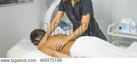 Back View Of A Woman Lying On A Table And Beauty Specialist Doing A Massage For Her, Spa Center Beau
