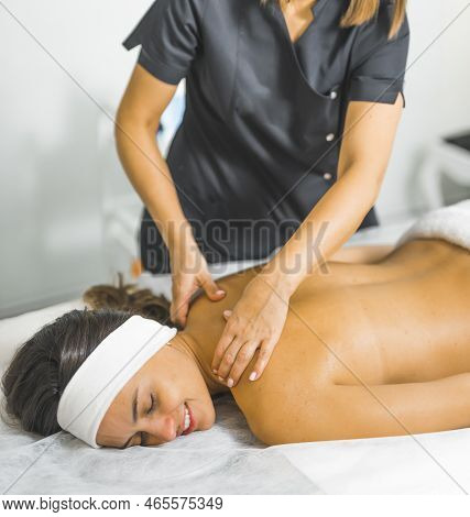 Vertical Shot Of A Charming Woman Lying On A Table And Getting A Massage At The Beauty Center, Mediu