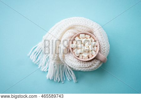 Hot Chocolate With Marshmallows In The Mug And Knitting Scarf. Fflat Lay Image On Blue.