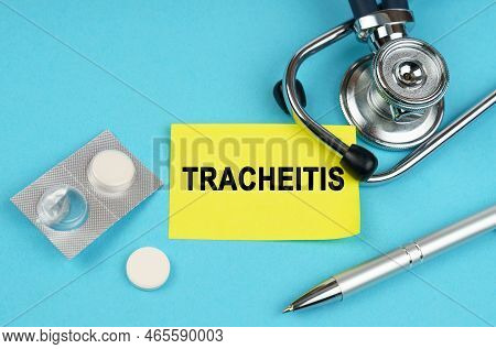 Medical Concept. On A Blue Surface, A Stethoscope, Pills, A Pen And A Yellow Sticker With The Inscri
