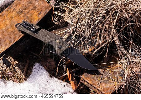 Folding Knife With Many Tools. Multifunctional Knife For The Military. Knife Lying On Hay And Rusty 