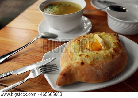 Fresh Delicious Adjarian Khachapuri With Cheese And Egg On Wooden Table
